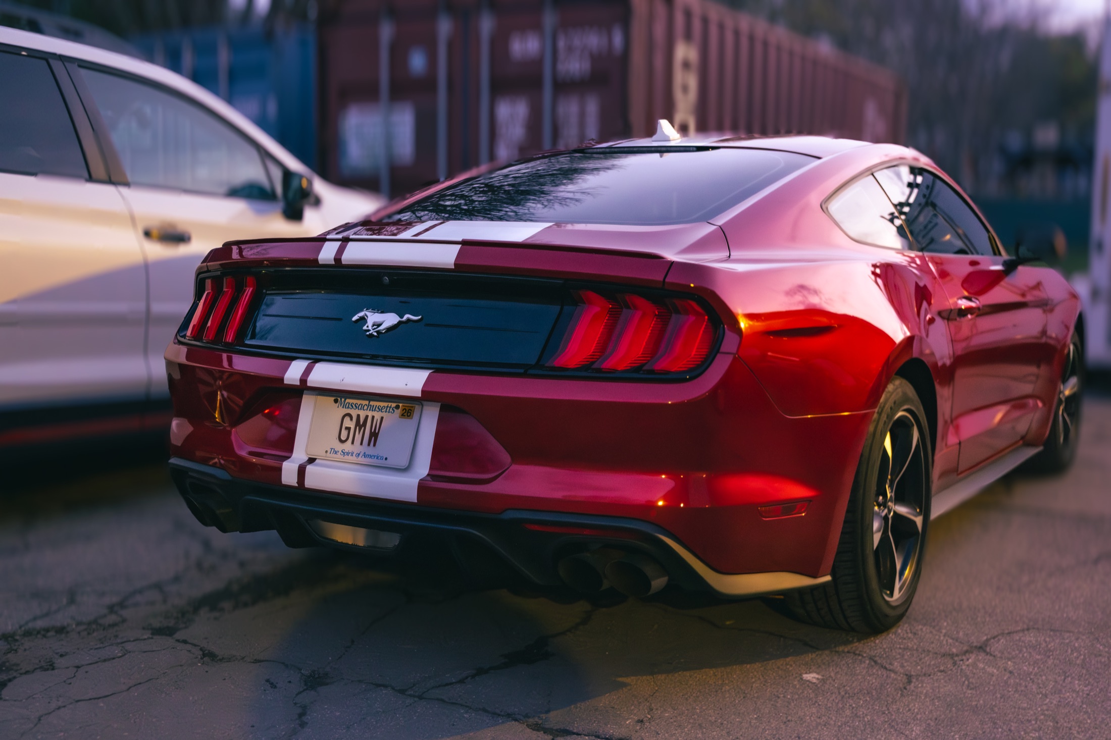 Red Ford Mustang parked at dusk